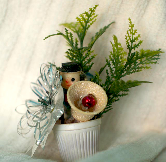 a bizarre little homemade christmas ornament in a creamer cup